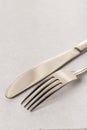 Silverware metal fork and knife on the white marble background with copy space copywritting Royalty Free Stock Photo