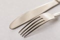 Silverware metal fork and knife on the white marble background with copy space copywritting Royalty Free Stock Photo