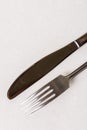 Silverware metal fork and knife on the white marble background with copy space copywritting Royalty Free Stock Photo