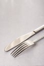 Silverware metal fork and knife on the white marble background with copy space copywritting Royalty Free Stock Photo