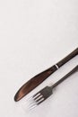 Silverware metal fork and knife on the white marble background with copy space copywritting Royalty Free Stock Photo