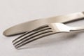 Silverware metal fork and knife on the white marble background with copy space copywritting Royalty Free Stock Photo