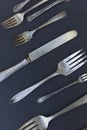 Weathered silverware of forks and knives in various sizes