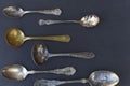 Weathered silverware of spoons in various sizes.
