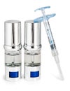 Silvery ampoules, small bottles, medical or cosmetic appointment and syringe