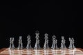 Silvery chess figures standing on chessboard