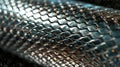 Silvery metal tubing with a linear scalelike pattern running along its length Royalty Free Stock Photo