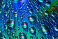 Silvery raindrops with blue and purple and green swirls on reflective metallic background asset