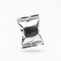 A silvery shiny foil packet with serrated edges, isolated on a white Royalty Free Stock Photo