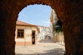 View to the street with historical buildings trough an arch in Silves, Portugal. Royalty Free Stock Photo