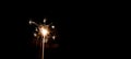 Silvester / New year background - Woman holds sparkling sparkler in her hand at dark night