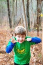 Sily six year old boy holding out six fingers Royalty Free Stock Photo