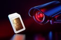 Sim card checked by cctv. Spying on mobile data transfers or phone calls concept. 3D rendering Royalty Free Stock Photo