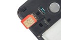 SIM card close-up next to the connector in the smartphone Royalty Free Stock Photo