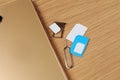 SIM cards, mobile phone and ejector tool on wooden table, flat lay