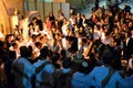 Jewish people celebrating Simchat Torah at western wall in the evening