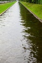 Simetrical artificial water channel in the city Royalty Free Stock Photo