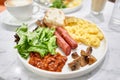 Simple American style Breakfast with sausages, scrambled eggs, baked beans, mushrooms and tomatoes. This dish is full of Royalty Free Stock Photo