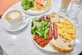 Simple American style Breakfast with sausages, scrambled eggs, baked beans, mushrooms and tomatoes. This dish is full of Royalty Free Stock Photo