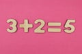 Simple arithmetic for children. Three plus two - equal to five on a bright pink background Royalty Free Stock Photo