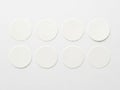 Eight circular white objects arranged in two rows isolated on white background Royalty Free Stock Photo