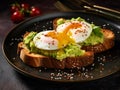 Simple avocado toast with poached egg on dark rye bread, close up. Sandwich with guacamole oar avocado dip and poached egg on dark