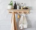 Simple bathroom interior - wooden shelf with a towel, shampoo,  flower. Minimalism style, Scandinavian style home Royalty Free Stock Photo