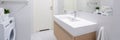 Simple bathroom with long washbasin, panorama Royalty Free Stock Photo