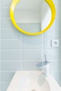 Simple bathroom with yellow mirror Royalty Free Stock Photo