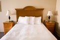 Simple bed, headboard, nightstands, lamps Royalty Free Stock Photo