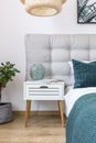 Simple bedroom with white nightstand