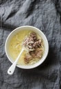 Simple beef broth with beef meat, onion and pepper on grey background. Healthy food, soup base