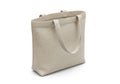 A simple beige canvas tote bag with two handles stands on a white surface Royalty Free Stock Photo