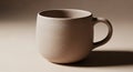 Simple, beige ceramic mug with a smooth, matte texture sits against a neutral background. The mug Royalty Free Stock Photo