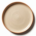 A simple beige plate with a brown rim sits empty on a white studio background. Top down view shows clean, minimalist ceramic Royalty Free Stock Photo
