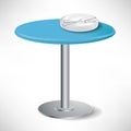 Simple blue round table with plates Royalty Free Stock Photo