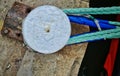 Simple Bollard on the shore, with turquoise rope Royalty Free Stock Photo