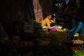 A simple boy is selling vegetables on a street market in India