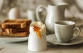 Simple breakfast concept: close up on the boiled egg, rest of setting blurred