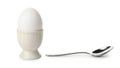 Simple breakfast scene featuring a boiled egg in an egg cup with a spoon Royalty Free Stock Photo