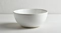 A simple ceramic bowl with a smooth, glossy finish. Its white color is consistent Royalty Free Stock Photo