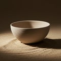 Simple ceramic bowl with a smooth, unglazed surface, placed on fine sand. The bowl Royalty Free Stock Photo