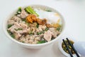 Simple Chinese pork noodle soup with eggs served with lard and chili pepper