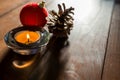 Simple Christmas background image, entering natural light, pine cone, red ball, focus on the candle