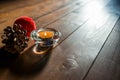 Simple Christmas background image, entering natural light, pine cone, red ball, focus on the candle Royalty Free Stock Photo