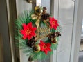 Simple Christmas wreath is hanging on the front door handle Royalty Free Stock Photo