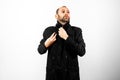 Simple and clean portrait of middle-aged man wearing his black raincoat to hide his face