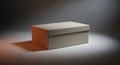Simple closed beige box with a lid under dramatic spotlight on a gray surface Royalty Free Stock Photo