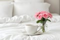simple Coffee cup and pink carnations in the vase on white bed background Royalty Free Stock Photo
