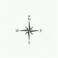 A simple compass rose design featuring a star-like shape with eight points. The Royalty Free Stock Photo